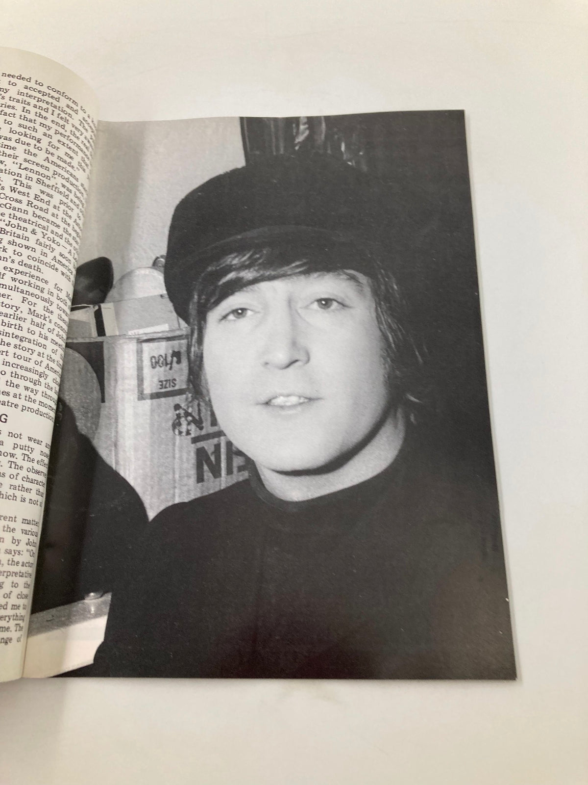 Black and white portrait of a band member wearing a hat in The Beatles Book Monthly Magazine, December 1985 Issue #116, capturing a candid moment in his life during the band's career.