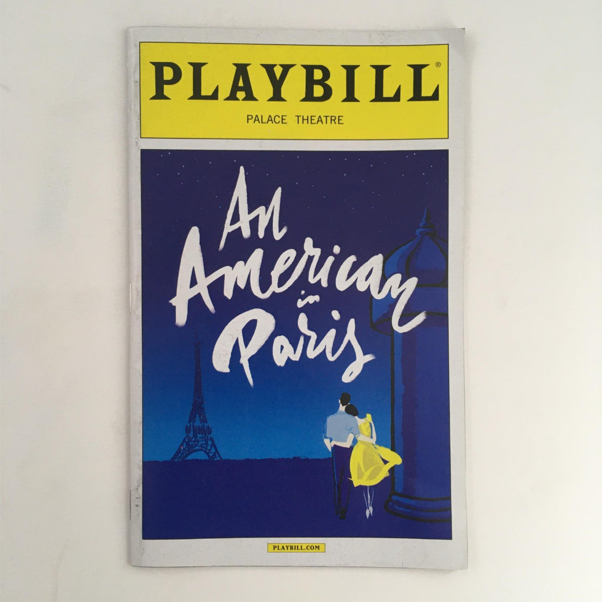 2015 Playbill An American in Paris cover featuring a couple in front of the Eiffel Tower at night, designed by Christopher Wheeldon, at the Palace Theatre.