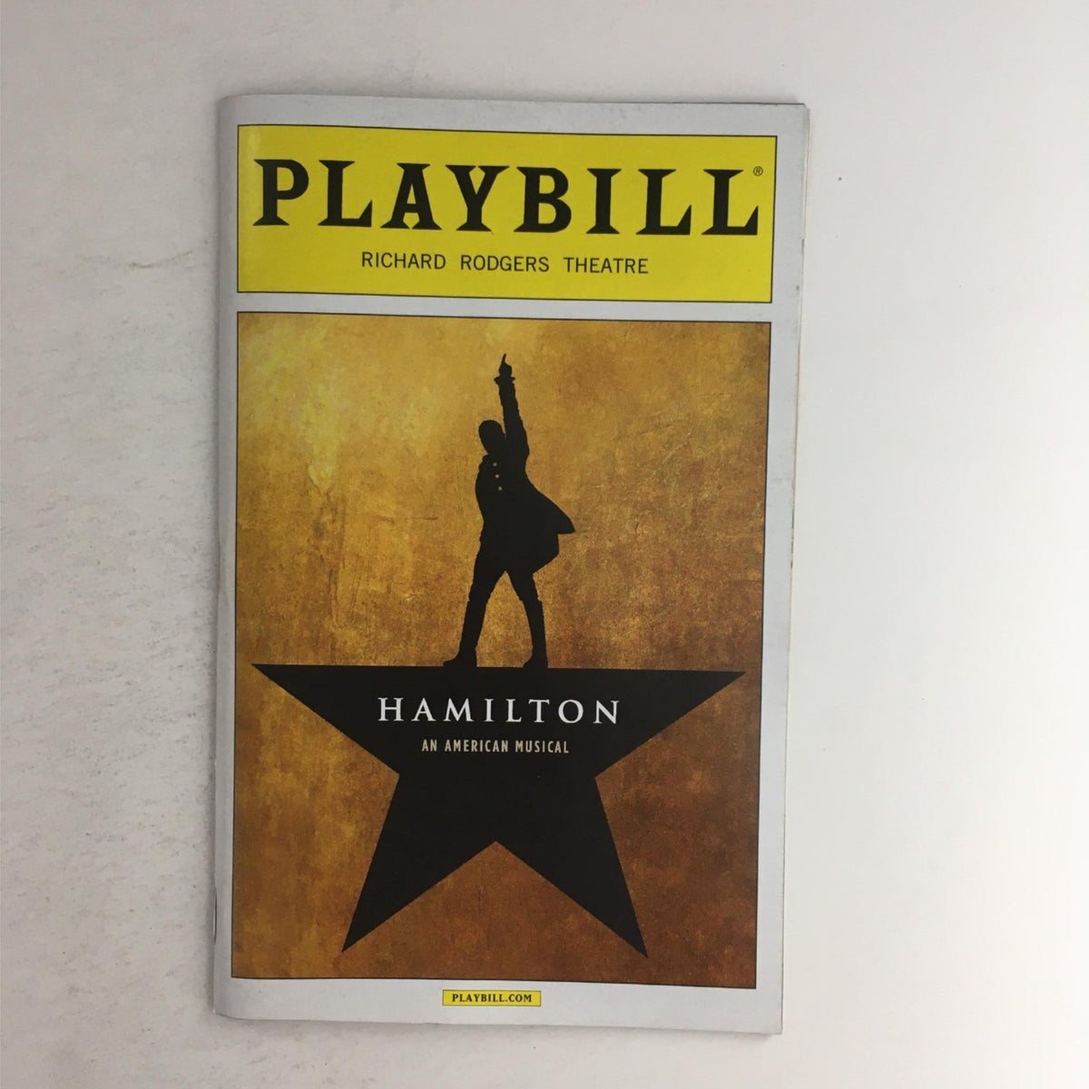 2015 Playbill Hamilton by Lin-Manuel Miranda at Richard Rodgers Theatre, featuring a striking cover design with a silhouette of Alexander Hamilton against a golden background.