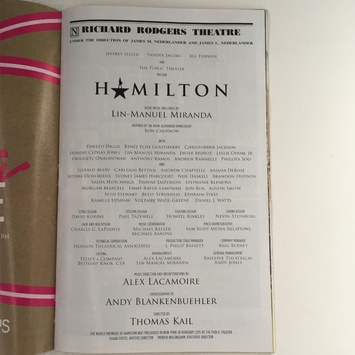 The cast list and production details of the Hamilton musical in the 2015 Playbill, featuring Lin-Manuel Miranda, displayed at Richard Rodgers Theatre.
