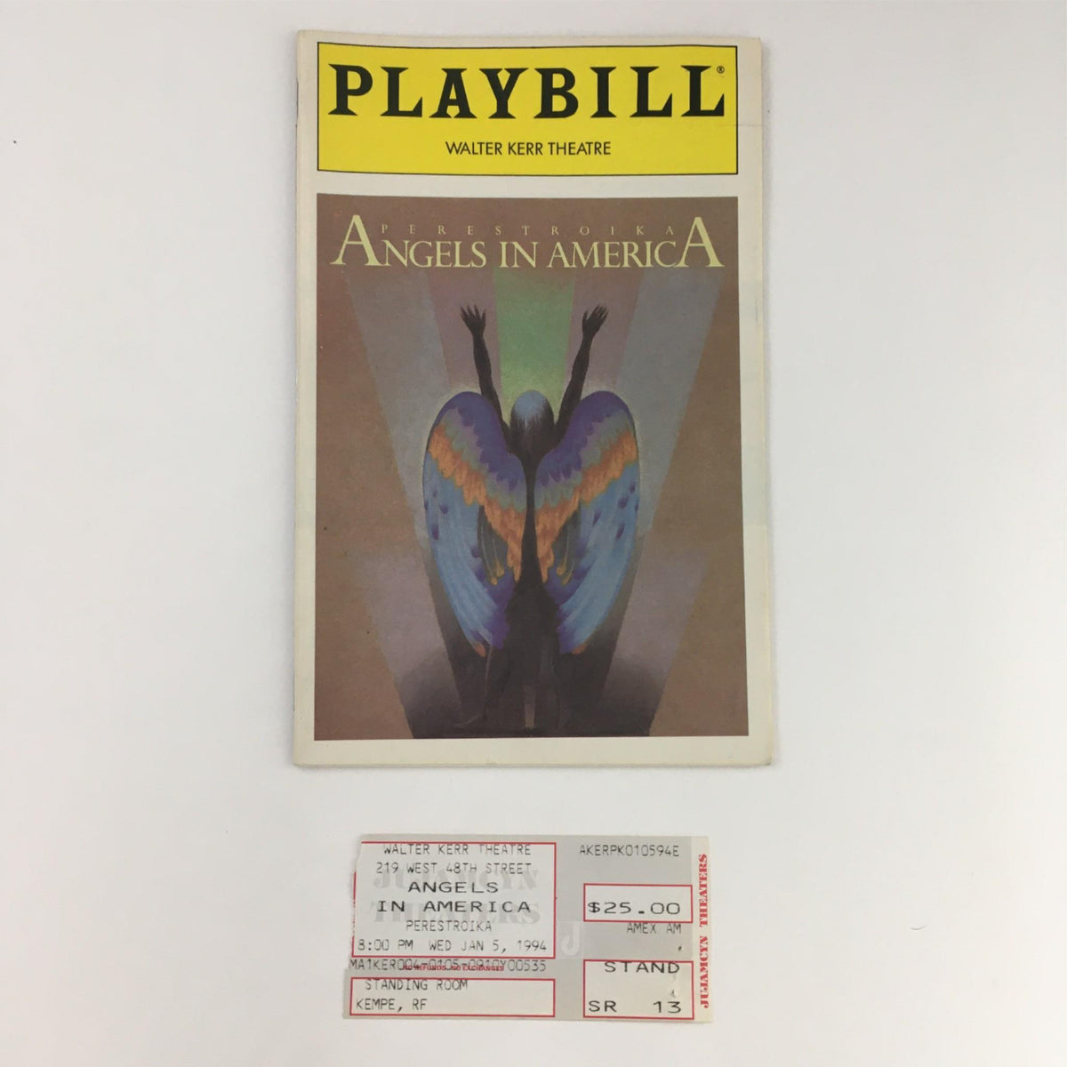 1994 Playbill for 'Angels in America' at Walter Kerr Theatre, featuring a colorful angel illustration on the cover and an original ticket stub.
