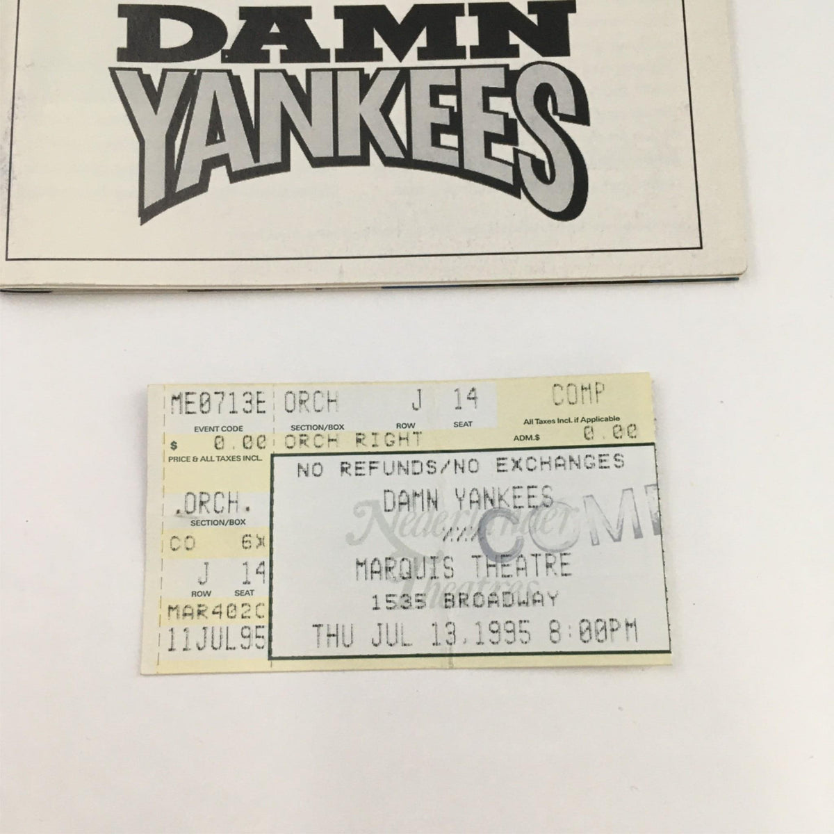 Close-up of the 1995 Damn Yankees Playbill and original ticket from the Marquis Theatre, highlighting the title and details of the performance.