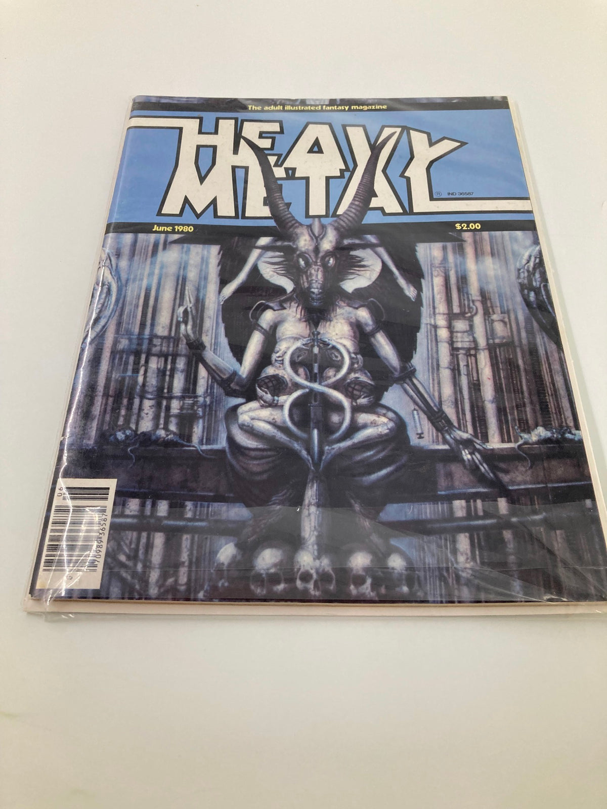 Cover of the VTG Heavy Metal Magazine June 1980, depicting the striking artwork of H.R. Giger's 'The Necronomicon', showcasing a mix of fantasy and science fiction elements.