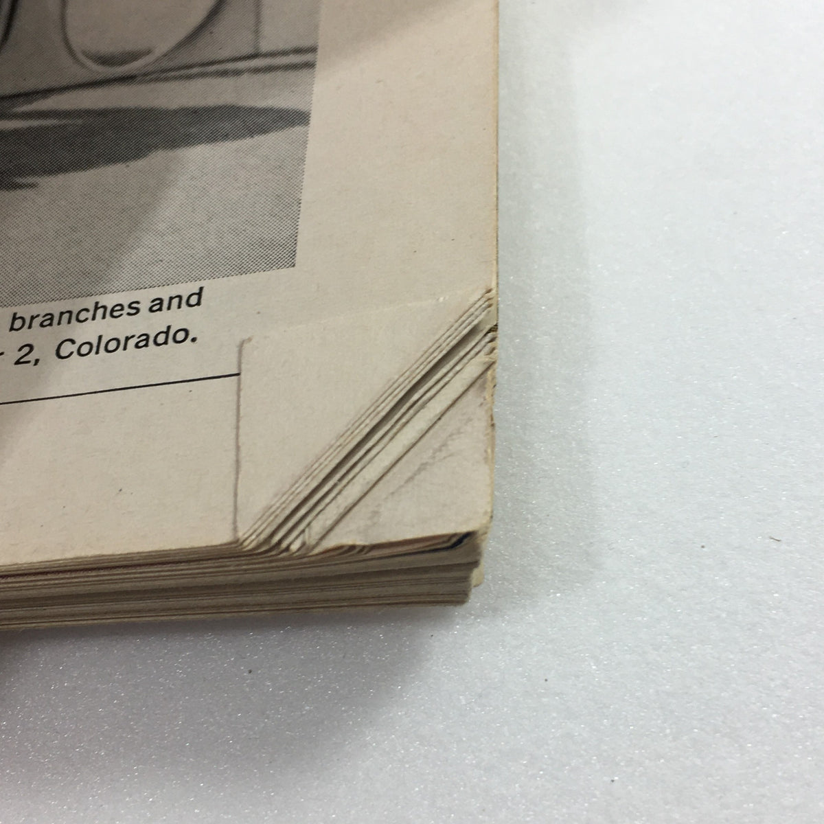 Detail of the side of Vintage Playboy Magazine October 1961 showing wear at the edges, emphasizing its vintage charm and authenticity.