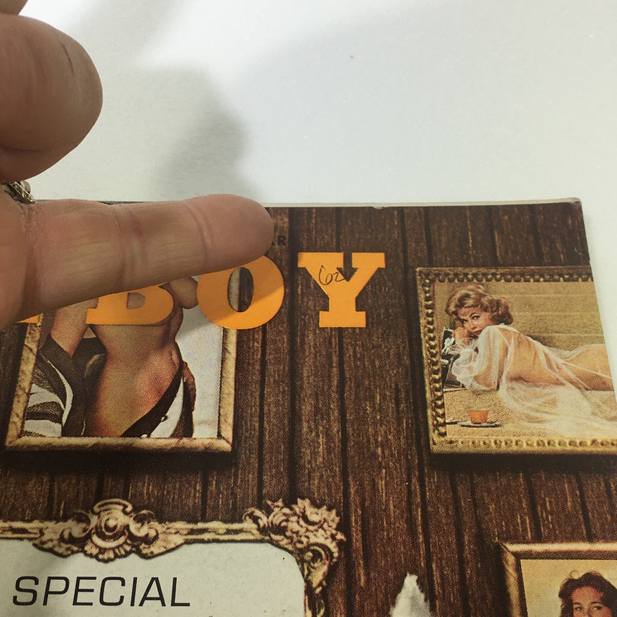 Close-up of the title section of VTG Playboy Magazine January 1962 Vol. 9 #1, highlighting the signature orange typography and framed illustrations on the cover.