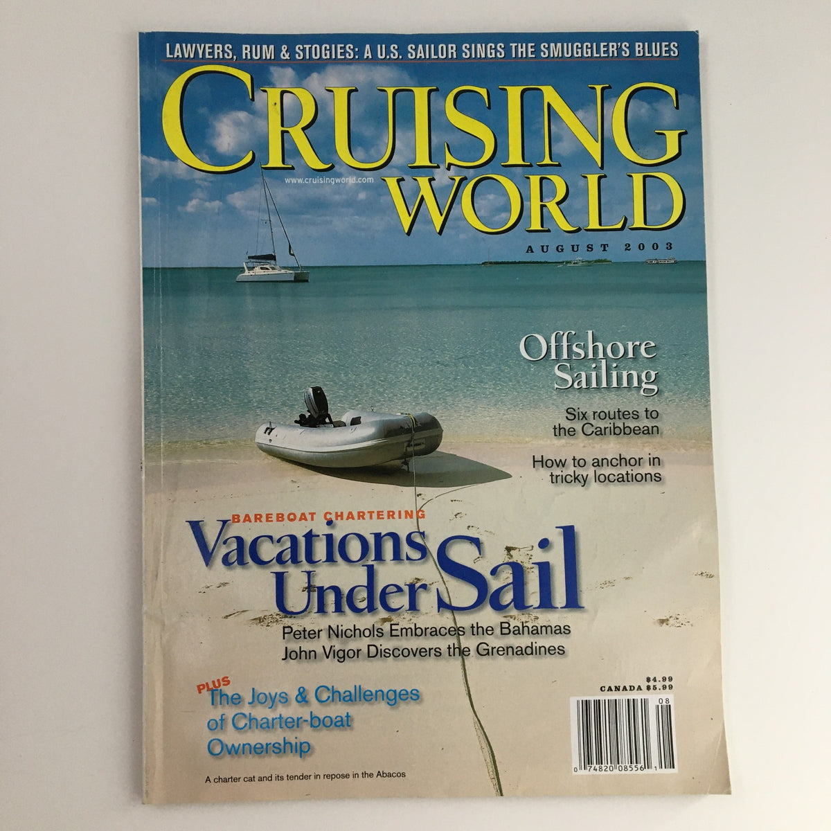 Cruising World Magazine August 2003 featuring articles by Peter Nichols and John Vigor, showcasing a sailboat anchored near a serene beach, and discussing offshore sailing and charter boating challenges.
