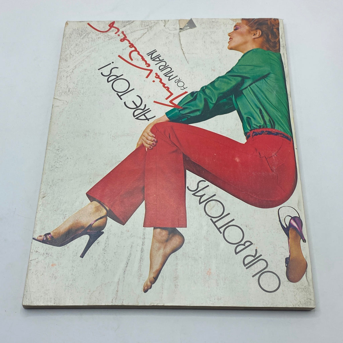 VTG Vogue Magazine January 1980 cover featuring a model in a green top and red pants, showcasing fashion trends from the 1980s by photographer John Stember.