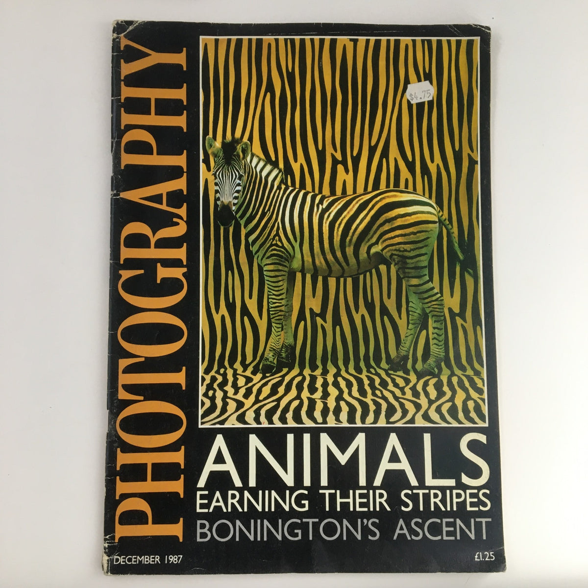 Cover of Photography Magazine December 1987 featuring the article 'Animals Earning Their Stripes' with a striking image of a zebra against a bold striped background.