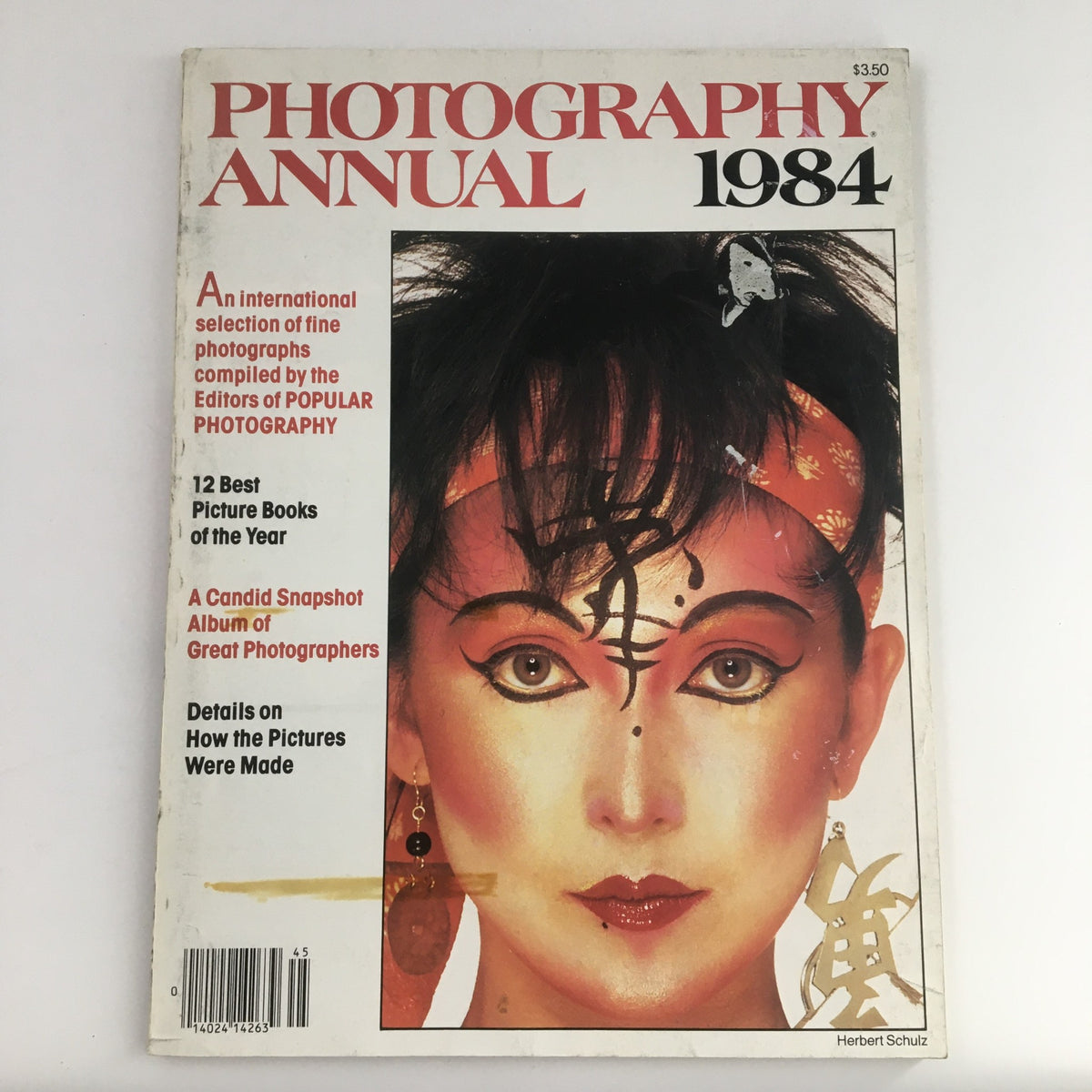 Cover of the Photography Annual Magazine 1984 Album of Great Photographers featuring a striking portrait with artistic makeup and accessories, showcasing the creative spirit of the 1980s.