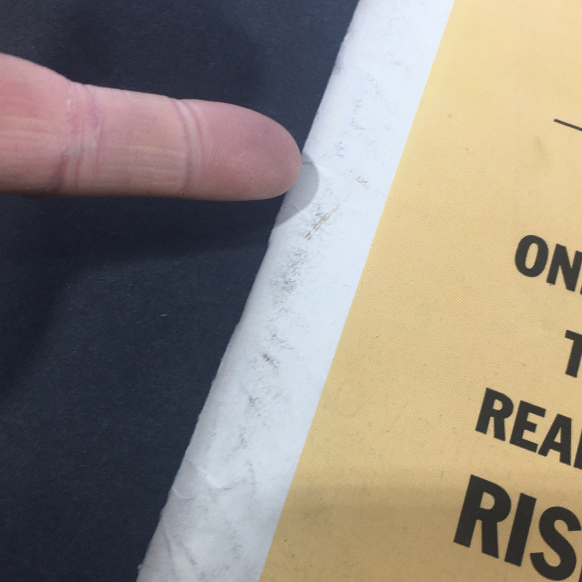 Close-up view of the edge of the VTG U.S. News & World Report Magazine May 28 1962, showing visible wear and a finger pointing at the condition, highlighting 'John F. Kennedy's Big Worry' as the cover story.