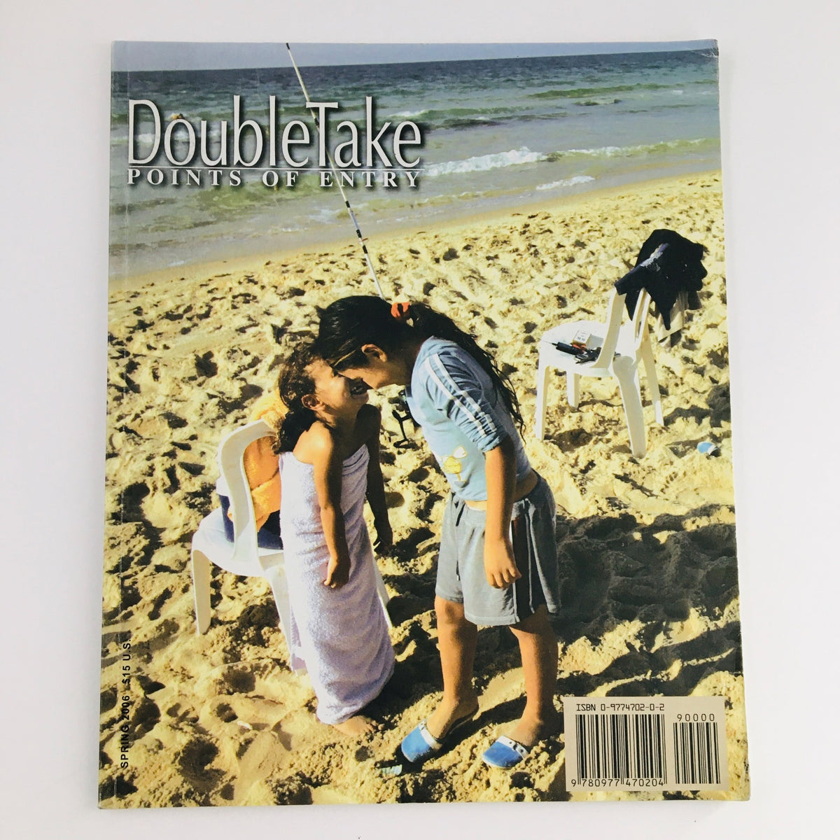 Cover of Doubletake Points of Entry 1:1 Spring 2006, featuring two children playing on a beach, highlighting themes related to the life of a migrant community.