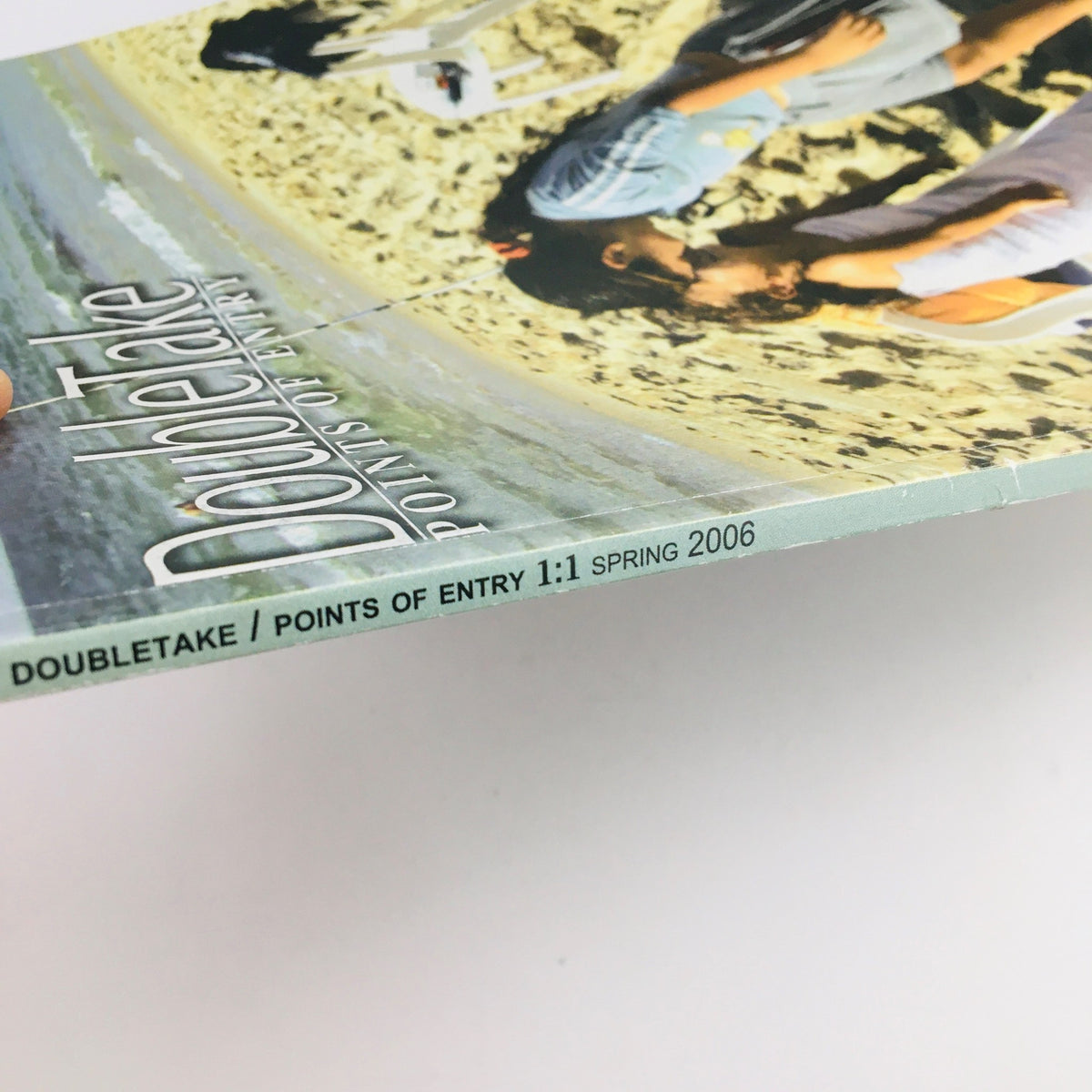 Cover page of Doubletake Points of Entry 1:1 Spring 2006, featuring an image of individuals on a beach.