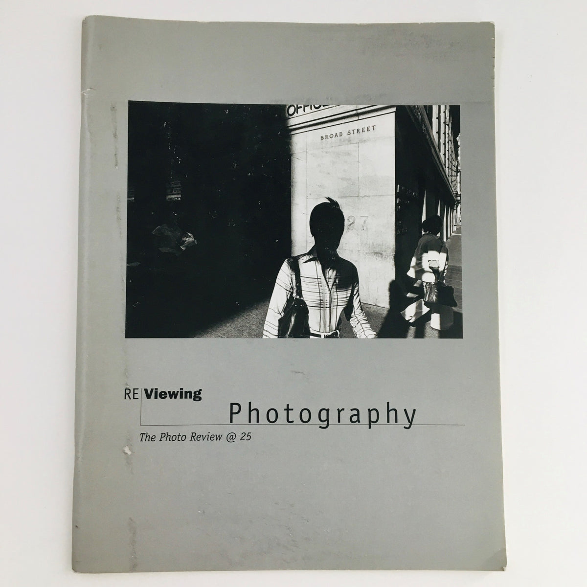 Cover of Re-Viewing Photography March 2002 showcasing a distinctive photographic image with two figures, representing the exhibition at the Rosenwald-Wolf Gallery.