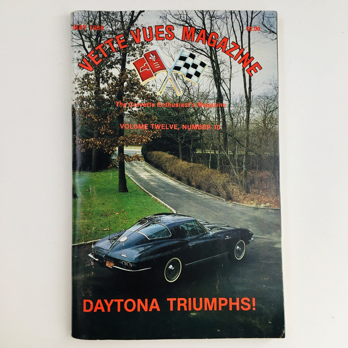 Cover of Vette Vues Magazine May 1984 Vol 12 #10 featuring the Daytona Triumphs, showcasing a classic Corvette parked on a scenic road, highlighting automotive history and vintage magazine aesthetics.