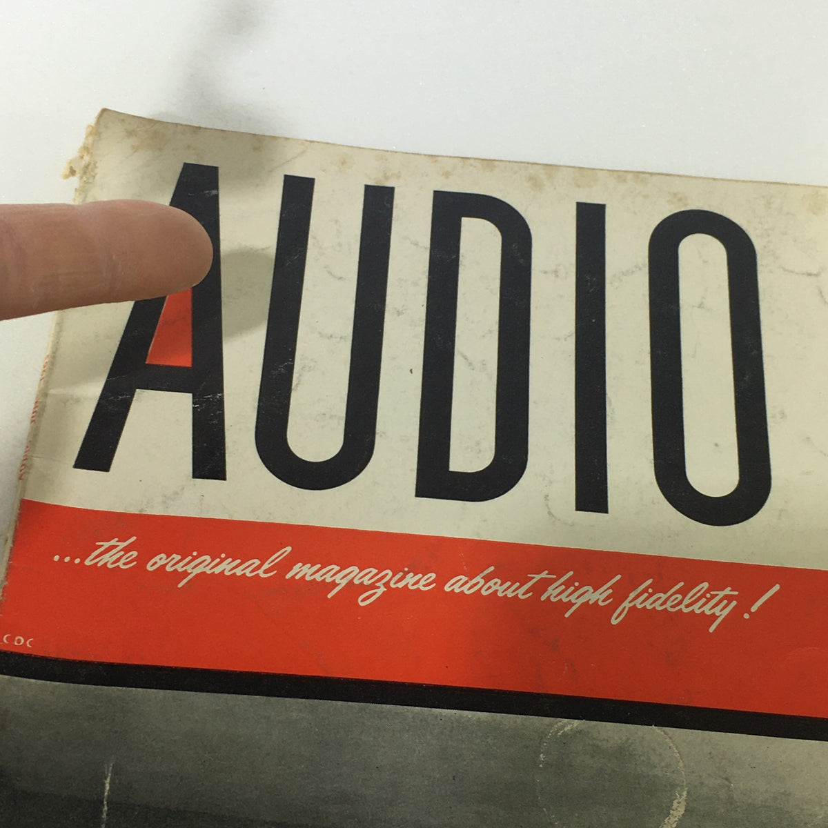 Close-up view of the cover of VTG Audio and Music Magazine June 1963, highlighting the word 'AUDIO' with a finger pointing at it, showcasing the vintage design and title.