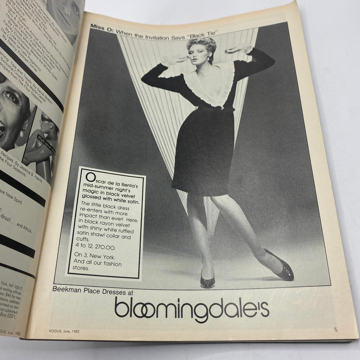 Page from VTG Vogue Magazine June 1982 featuring an elegant black dress styled with a white collar, showcasing a vintage fashion advertisement for Bloomingdale's.