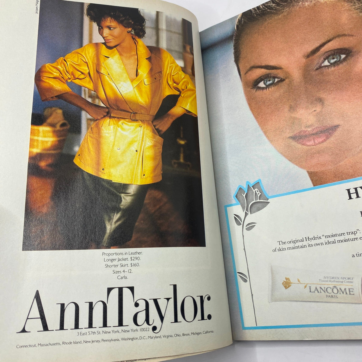 Page from VTG Vogue Magazine June 1982 displaying a striking yellow leather jacket in a fashion advertisement for Ann Taylor, highlighting 1980s fashion trends.