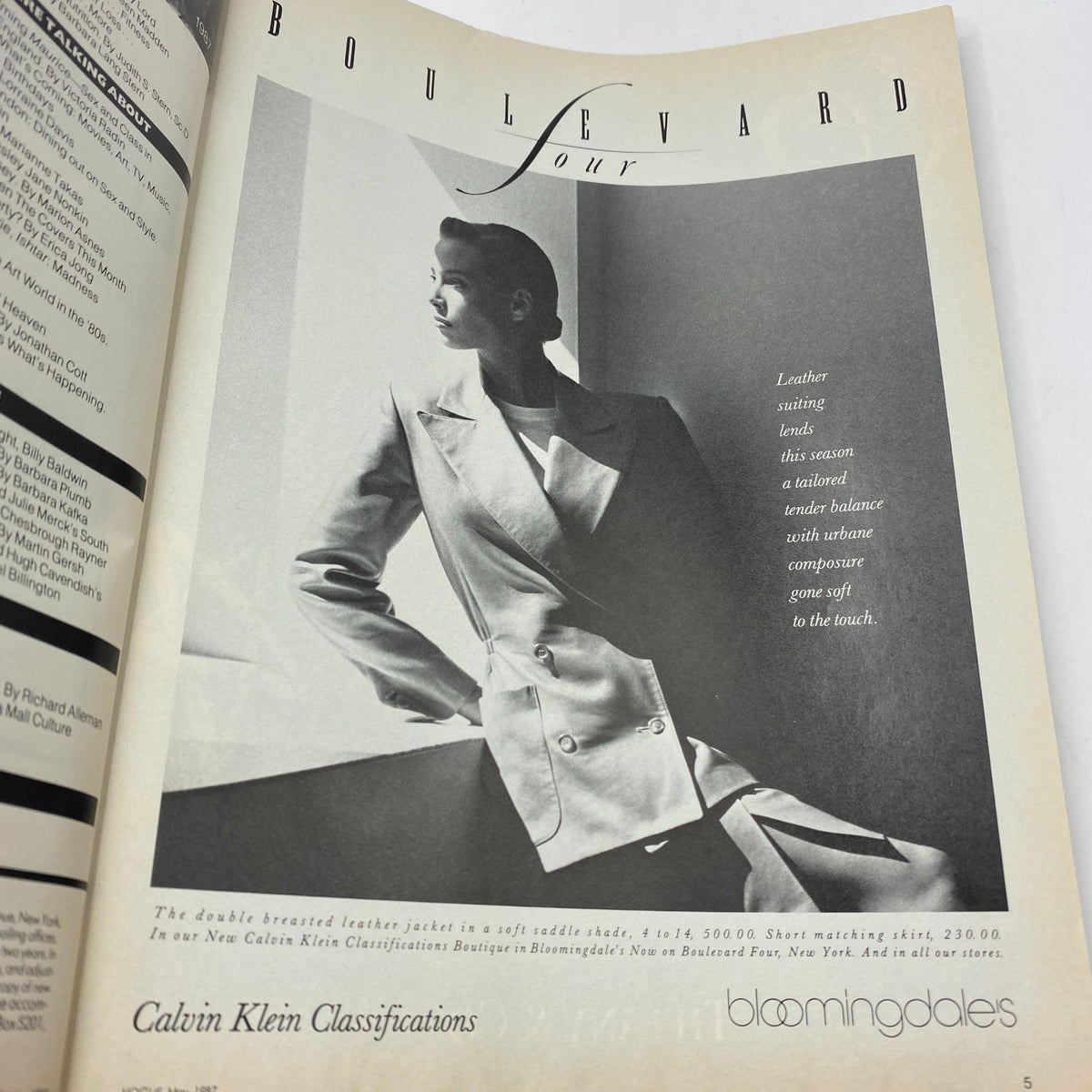 Boulevard section from VTG Vogue Magazine May 1987 featuring a stylish model in a tailored leather jacket and skirt. The image captures the essence of high fashion serialized in editorial shoots by Richard Avedon.