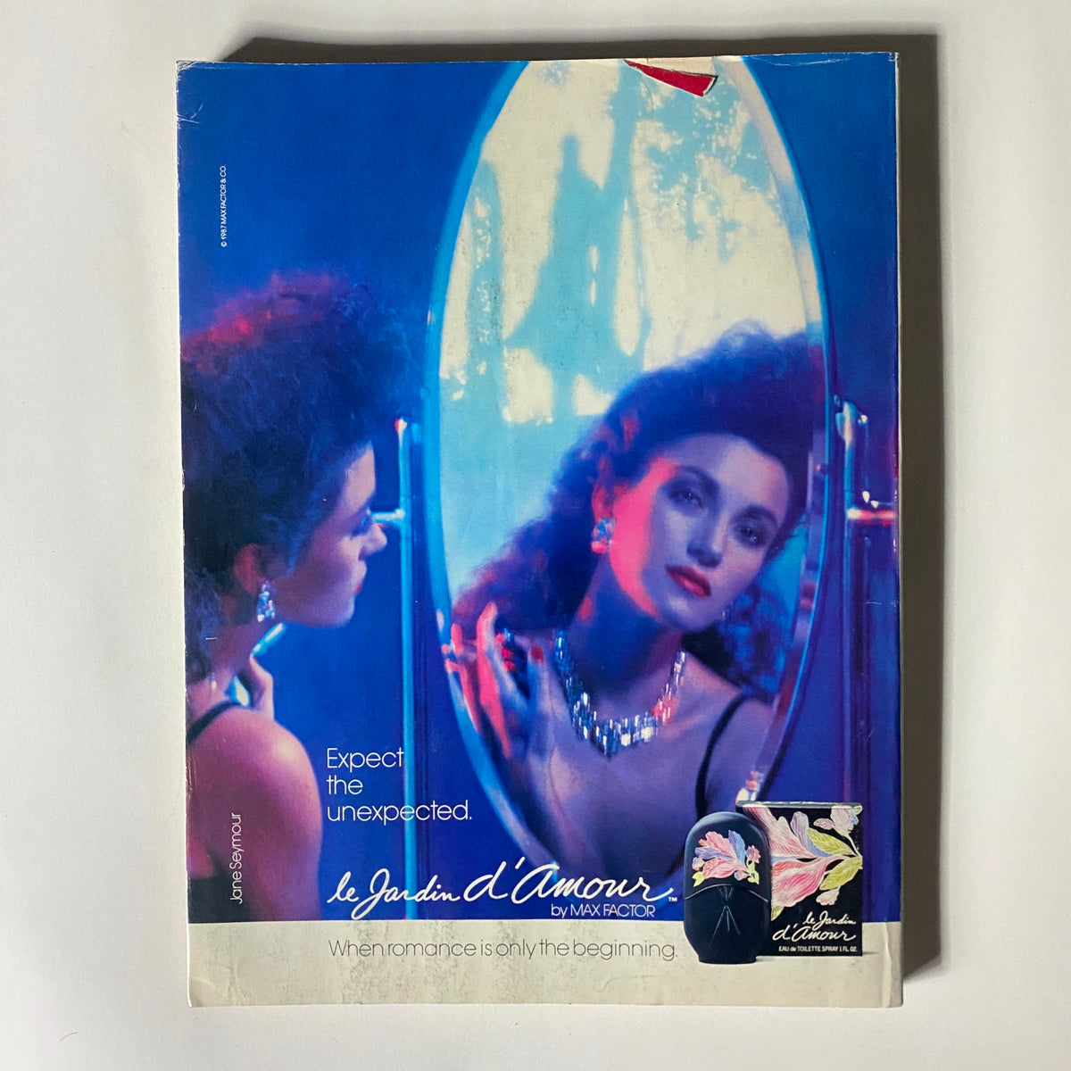 VTG Vogue Magazine May 1987 featuring an editorial spread with a model looking into a mirror, showcasing 1980s fashion and style, captured by renowned photographer Richard Avedon.