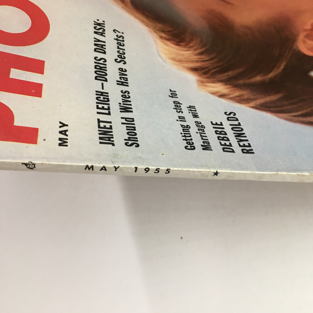 Side view of Photoplay Magazine May 1955 showing the publication date and article teasers, including topics on marriage and features about popular stars.
