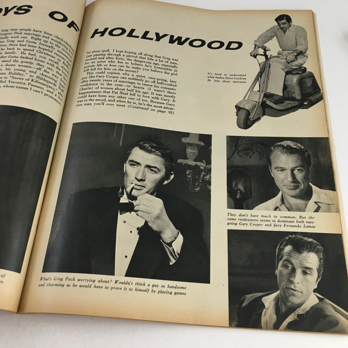 Interior page of the Photoplay Magazine December 1953 featuring articles and images about Hollywood actors, including a photo of a man in a tuxedo with a cigarette. This page is part of the Marilyn Monroe Pinup Calendar for 1954.