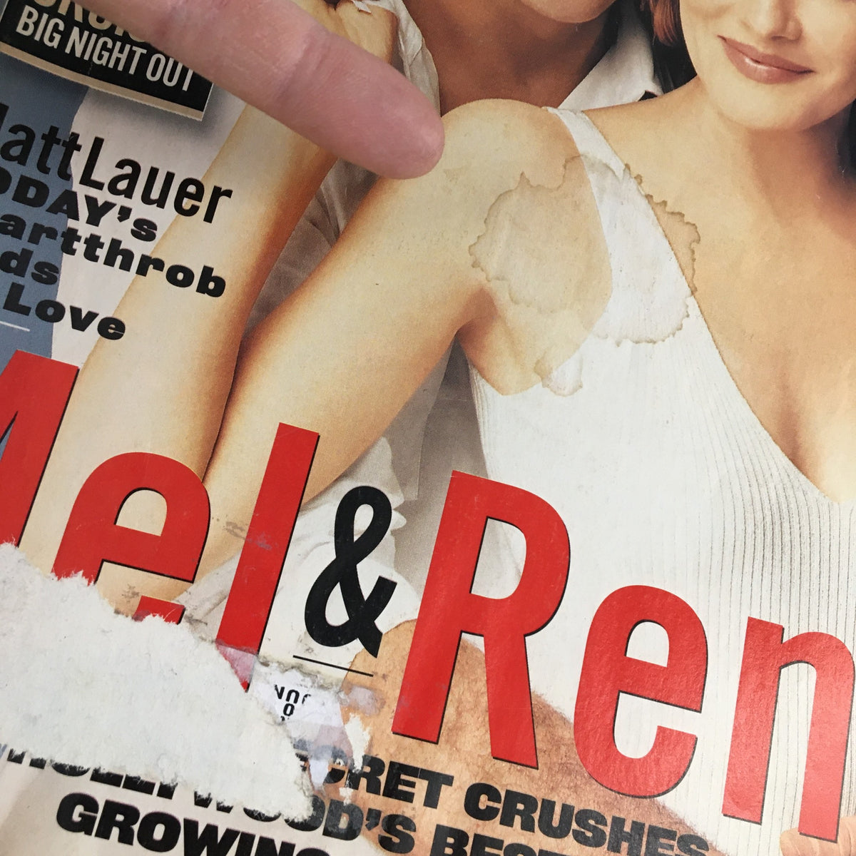 Cover of US Entertainment Magazine July 1996 featuring Mel Gibson and Rene Russo, showing wear with a noticeable tear and smudge on the front.