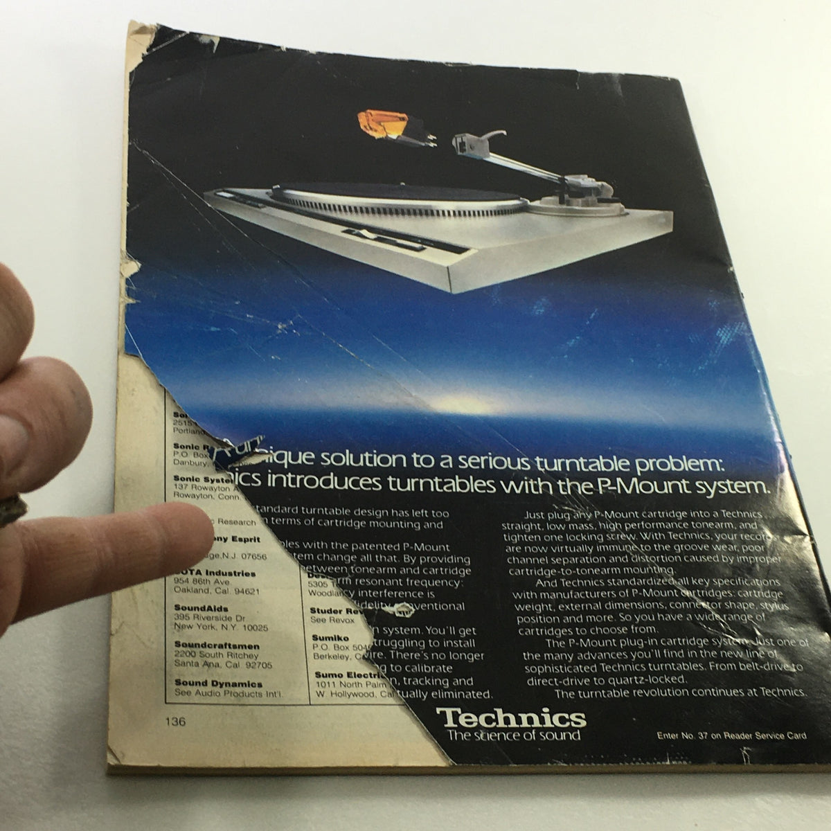 Back cover of VTG Audio and Music Magazine October 1982 showing a damaged section, featuring a Technics advertisement for P-Mount turntables and the unique features of this audio technology.