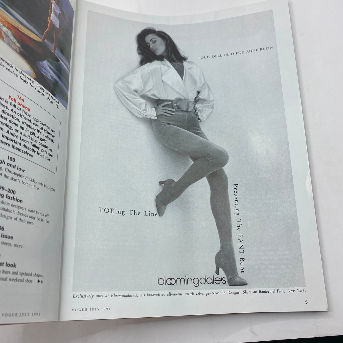Inside page of Vogue Magazine July 1991 displaying a black and white photo of a model in a stylish outfit with a belt. This article features the iconic styles of the early '90s.
