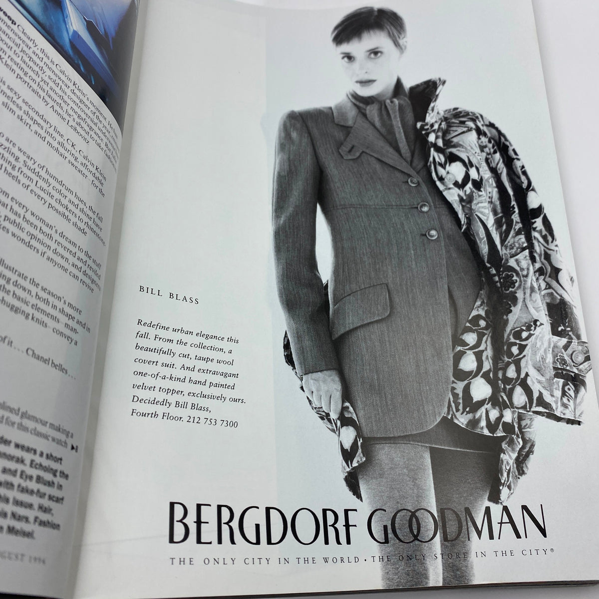 Vogue Magazine August 1994 featuring a black and white advertisement for Bill Blass, showcasing a model in urban elegance attire and a velvet topper, highlighting the fashion trends of the 90s.