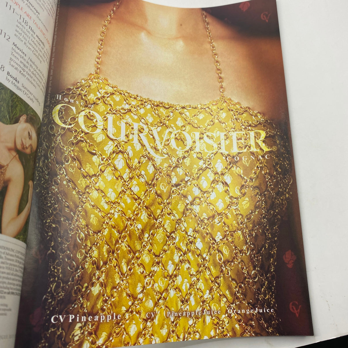 Close-up of a fashion spread in Vogue Magazine July 2001, showcasing a luxurious gold dress with intricate detailing.