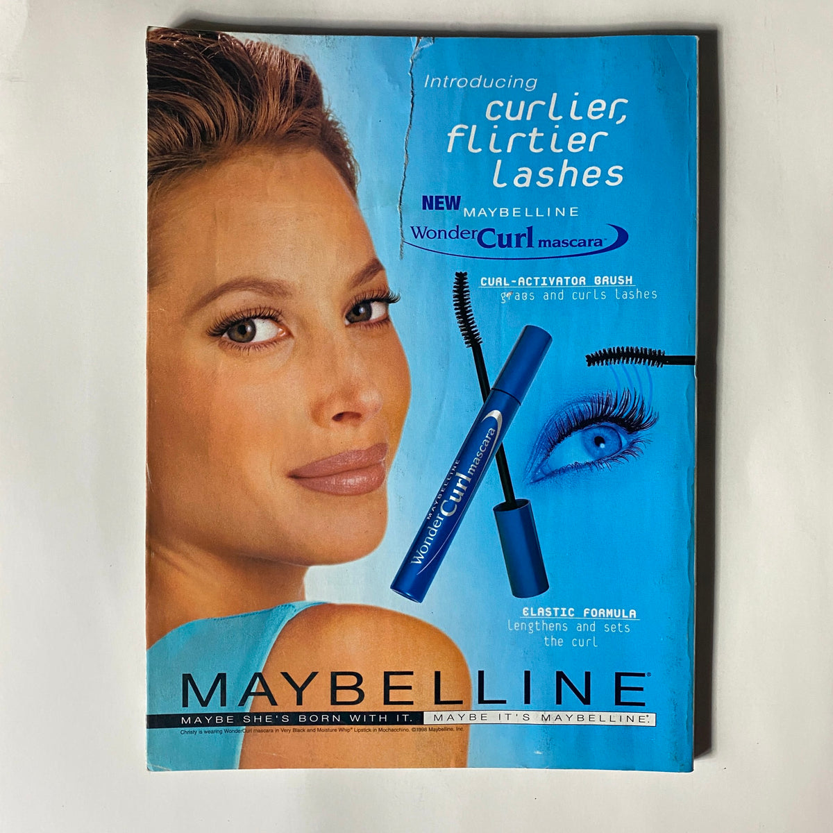 Vogue Magazine January 1999, introducing Maybelline's WonderCurl mascara with an advertisement showcasing a model with styled hair and voluminous lashes.