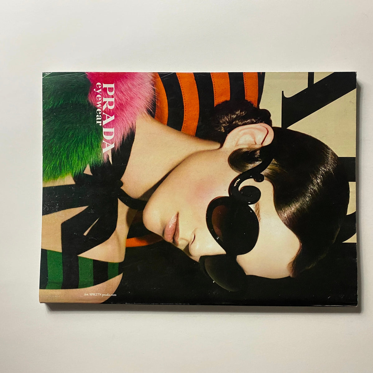 Vogue Magazine June 2011 Cover featuring Penelope Cruz, displaying a stunning advertisement for Prada with a model wearing oversized sunglasses and vivid colors, capturing the essence of high fashion.