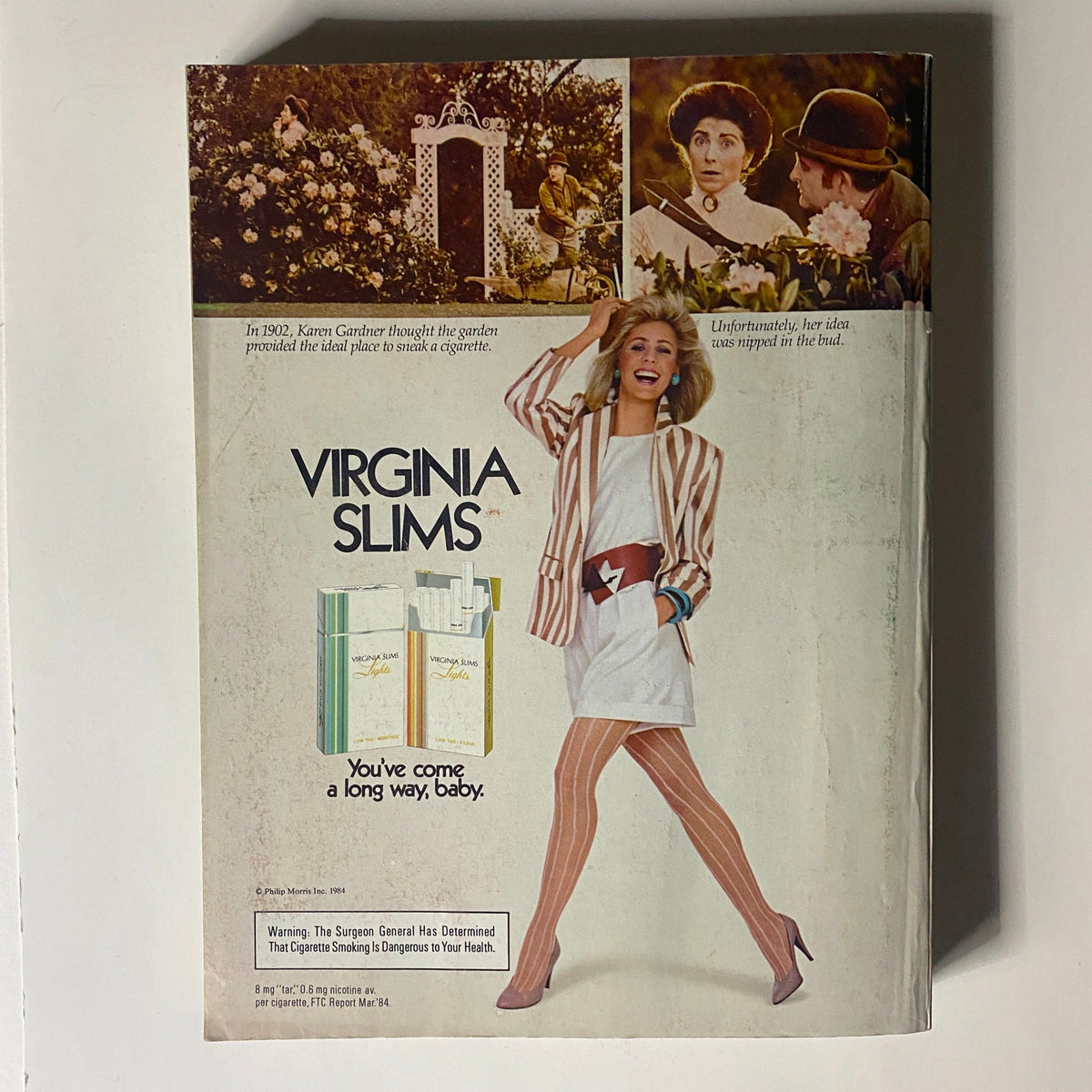 VTG Vogue Magazine October 1984 featuring a vintage Virginia Slims advertisement, depicting a fashionable model in a striped blazer and stylish knee-high stockings, illustrating 1980s lifestyle ads.