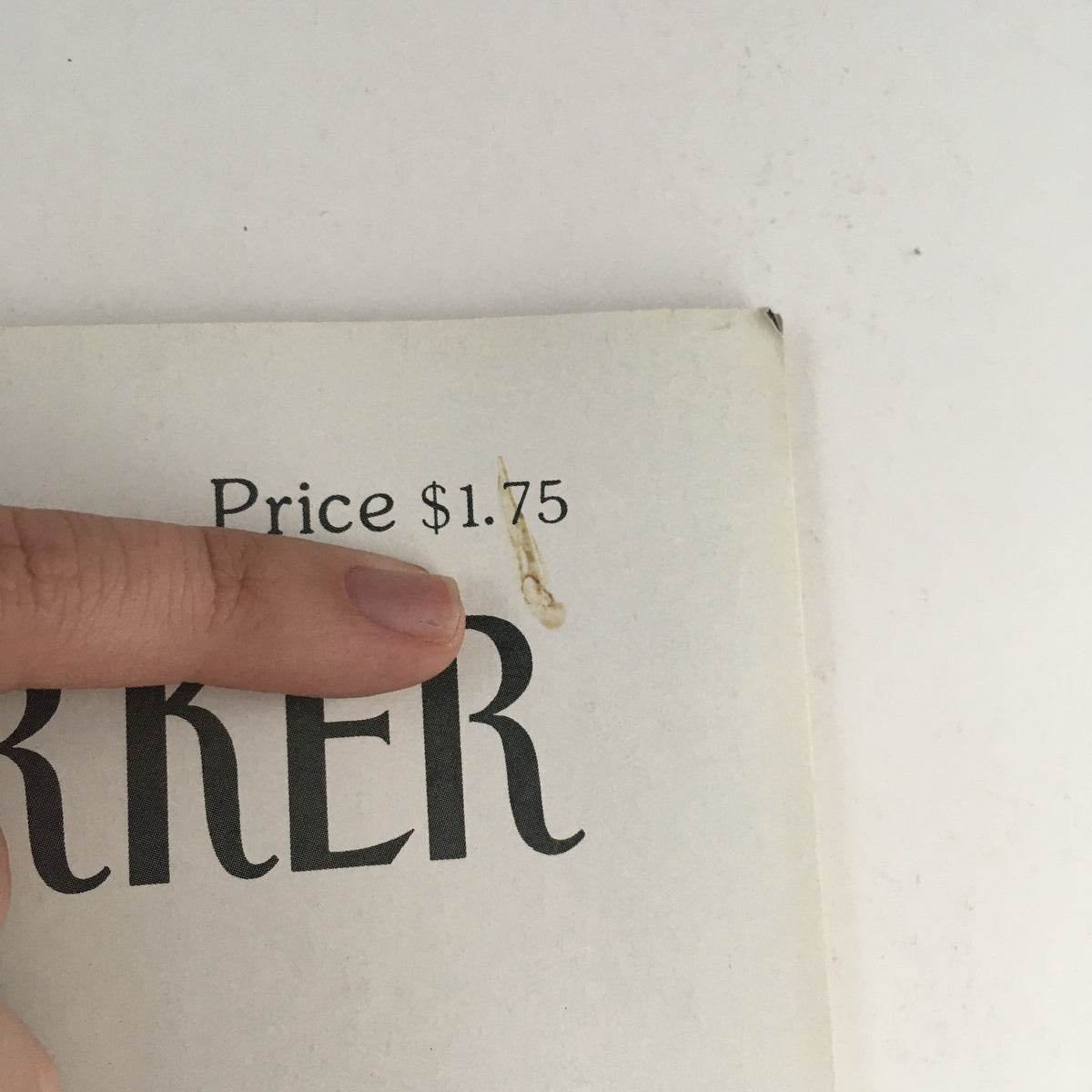 Close-up image of The New Yorker December 17 1990 magazine showing the price of $1.75, with a finger pointing at the price label, highlighting its vintage nature.