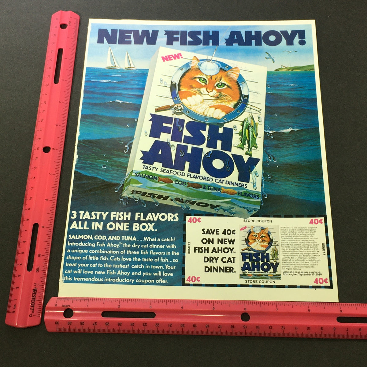 Revised image of the VTG Retro 1980 Fish Ahoy Tasty Seafood Flavored Cat Dinners Print Ad Coupon with a ruler for size reference, highlighting the cat-themed product and accompanying coupon savings information.