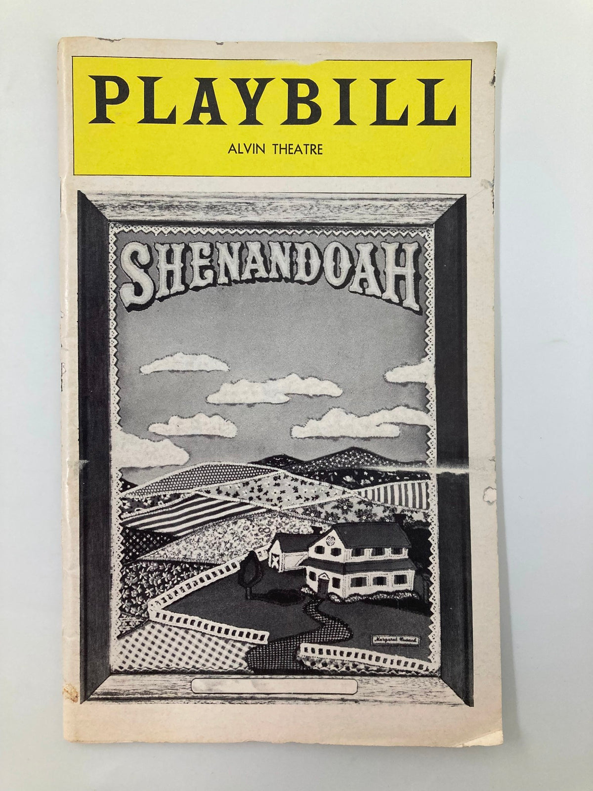Vintage 1976 Playbill for the musical 'Shenandoah' at the Alvin Theatre, showcasing a scenic illustration of rural landscapes and historic buildings.