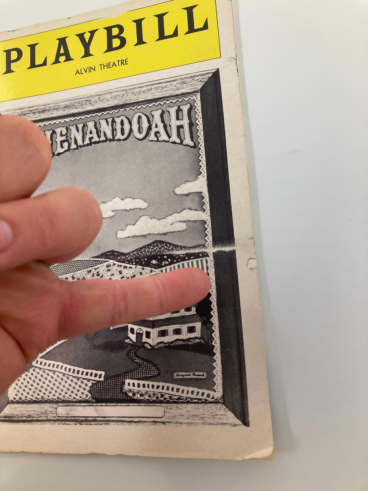 Close-up view of the 1976 Playbill for Shenandoah at Alvin Theatre, showing the title and some minor wear indicating its vintage condition.