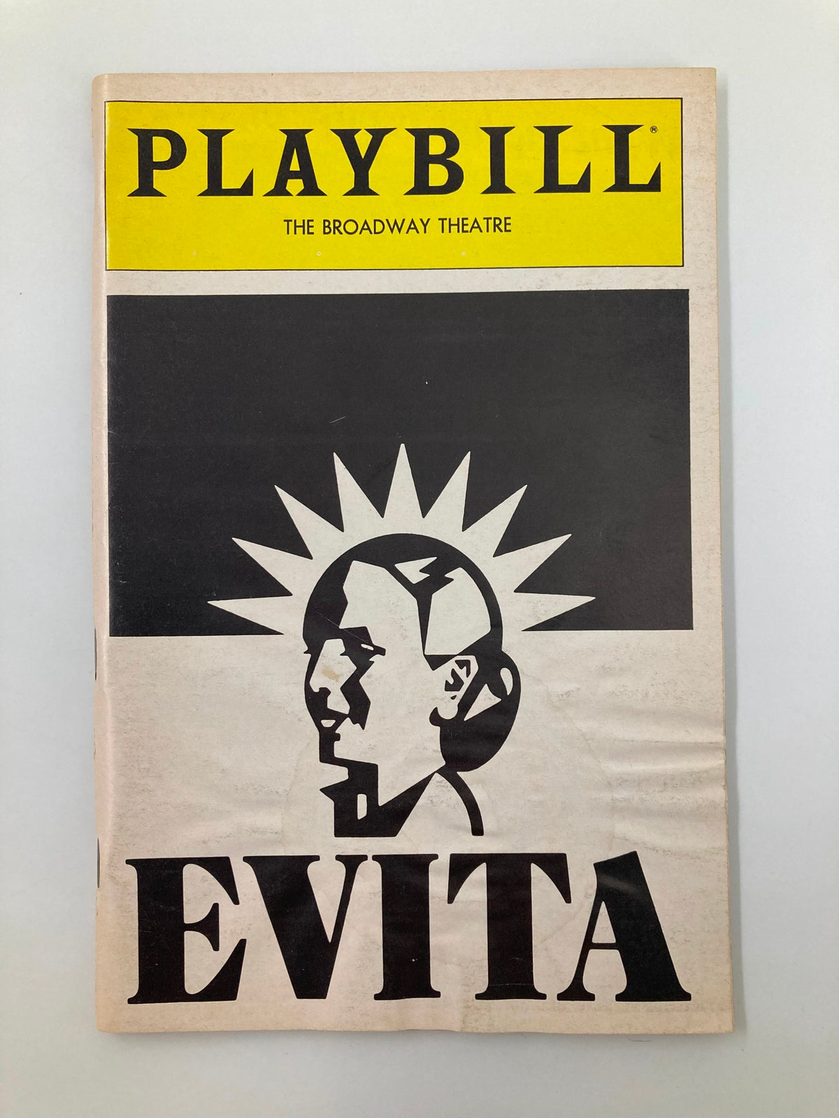 1982 Playbill for the Broadway Theatre production of Evita featuring a memorable design with a sun motif and the title 'EVITA' prominently displayed.
