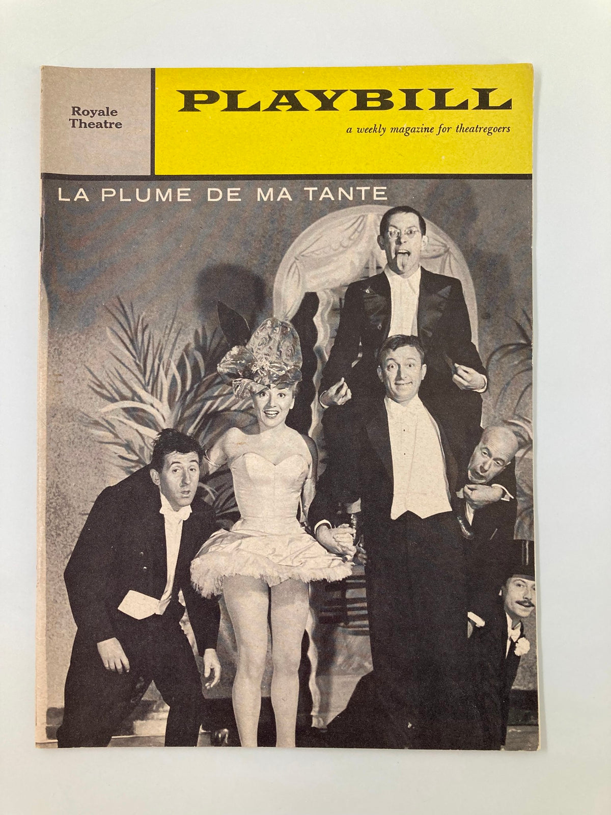 1959 Playbill from Royale Theatre featuring 'La Plume De Ma Tante' with actors in costume, including a female performer in a feathered headdress and male performers dressed in tuxedos.