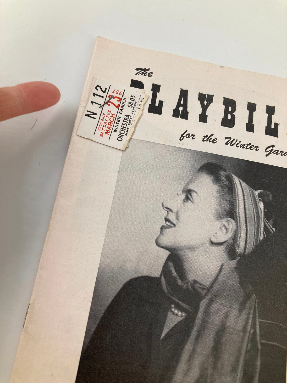 Close-up of a vintage 1957 Playbill for the Winter Garden featuring Beatrice Lillie, showcasing a ticket stub attached to the front page.