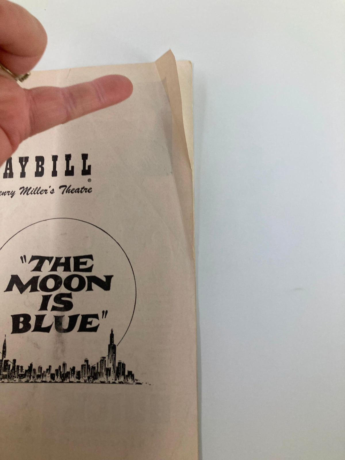 Close-up view of the 1953 Playbill for Henry Miller's Theatre, highlighting the title 'The Moon Is Blue' with minor signs of vintage wear.