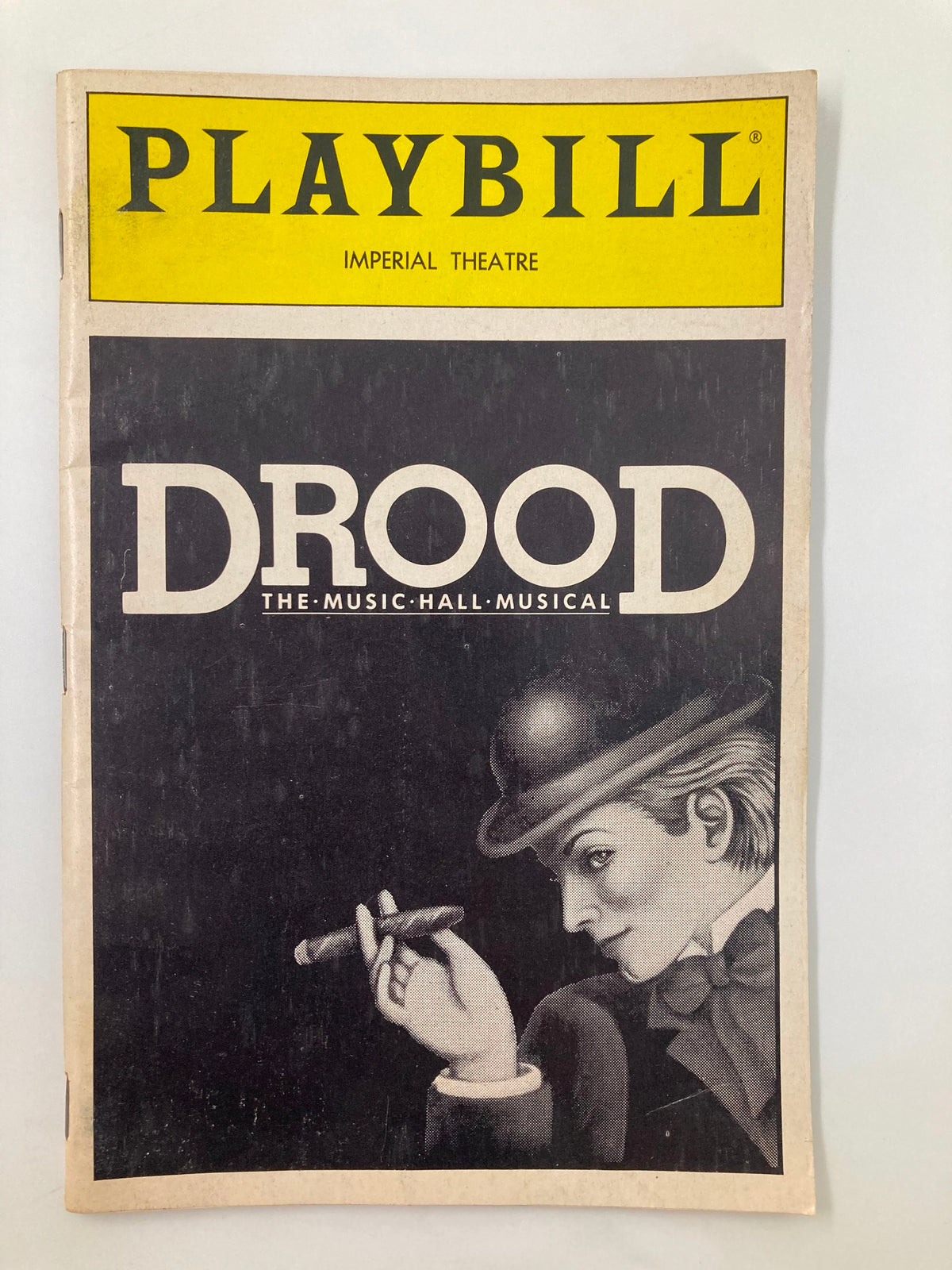 Cover of the 1987 Playbill for The Mystery of Edwin Drood at the Imperial Theatre, featuring an artistic depiction of a character with a cigar.
