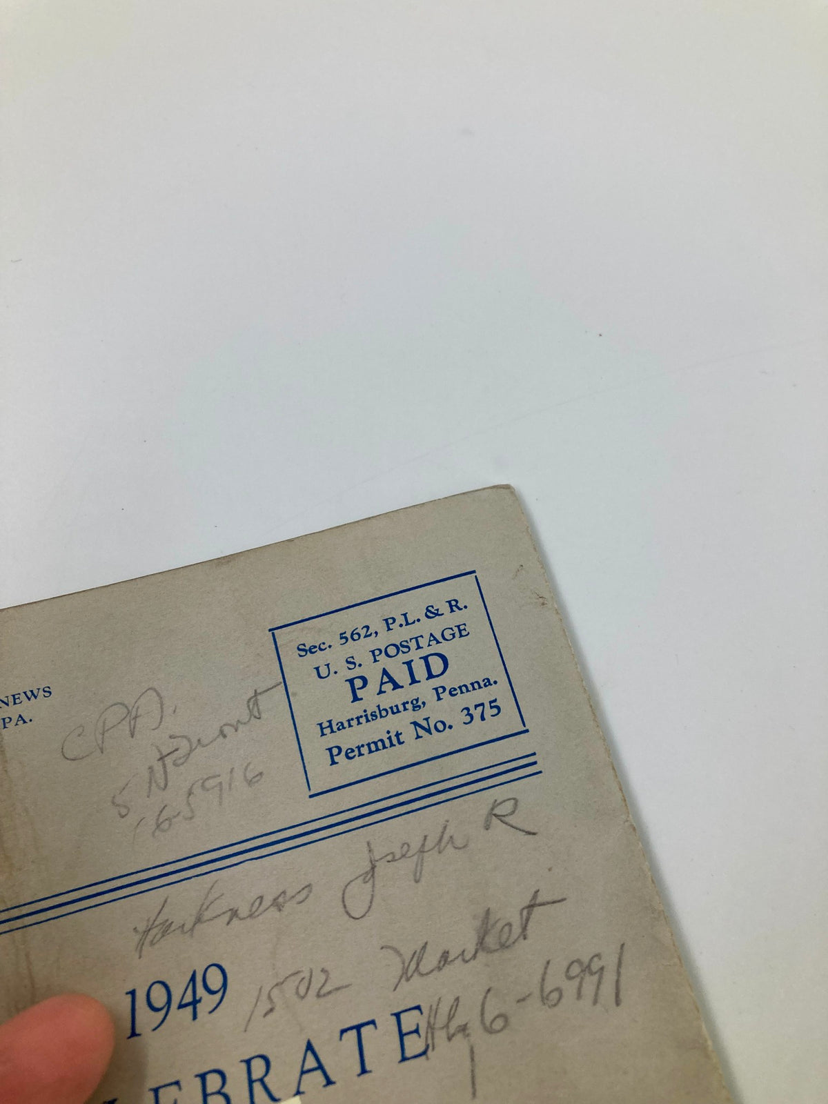 Back cover of the 1948 The Harrisburg Community Theatre Playbill for 'The Glass Menagerie' displaying handwritten notes and postal marks, reflecting its collectible status.