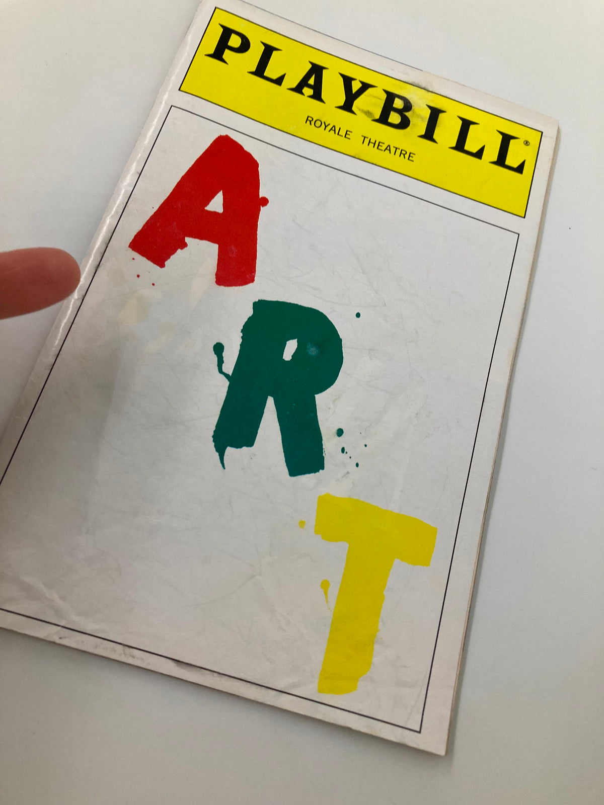 Close-up view of the 1998 Playbill for 'Art' at Royale Theatre showing the vibrant cover with the word 'ART' in red, green, and yellow.