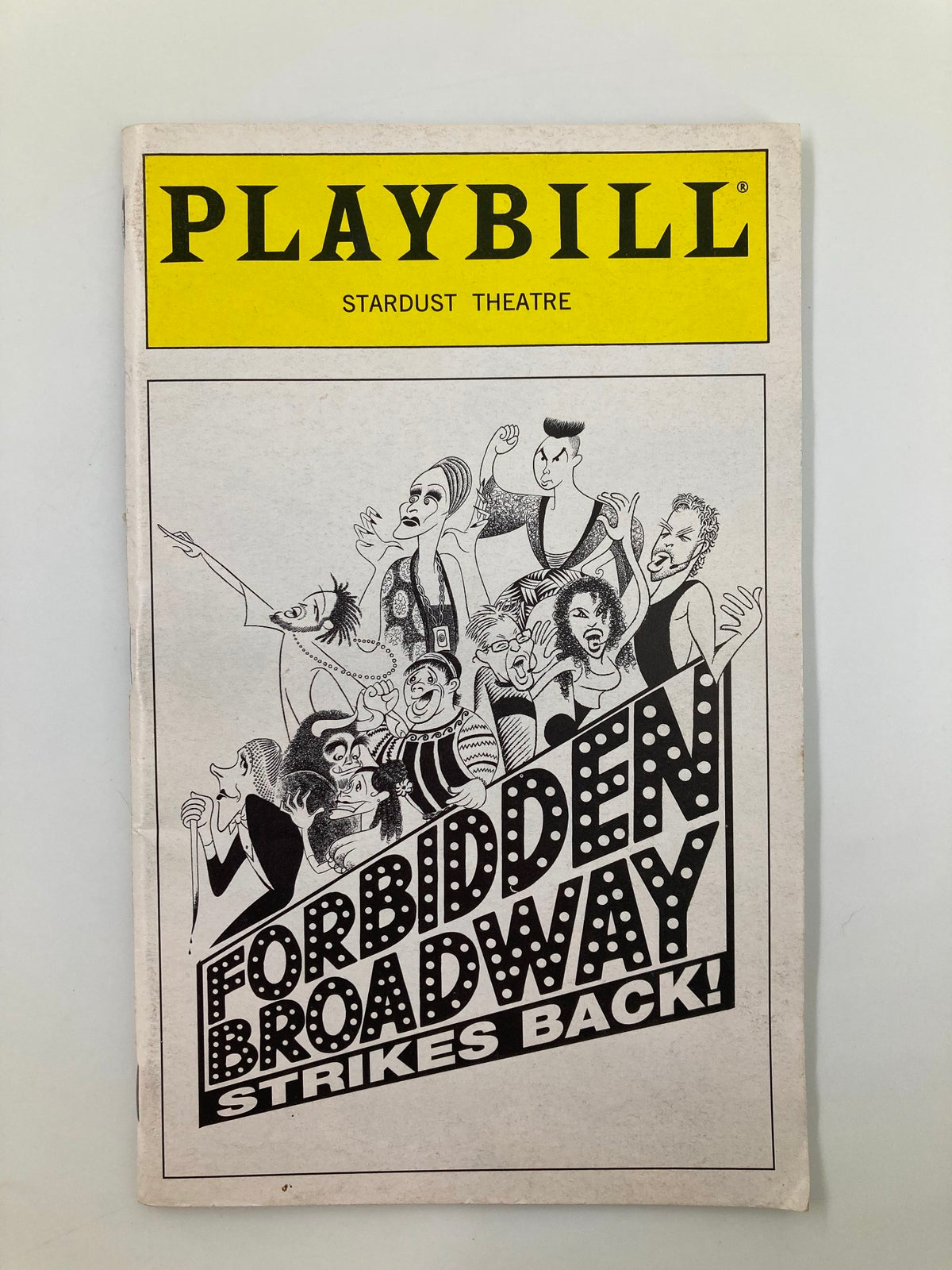 1998 Playbill for Forbidden Broadway Strikes Back at Stardust Theatre, showcasing characters and performers in a vibrant theatrical design.