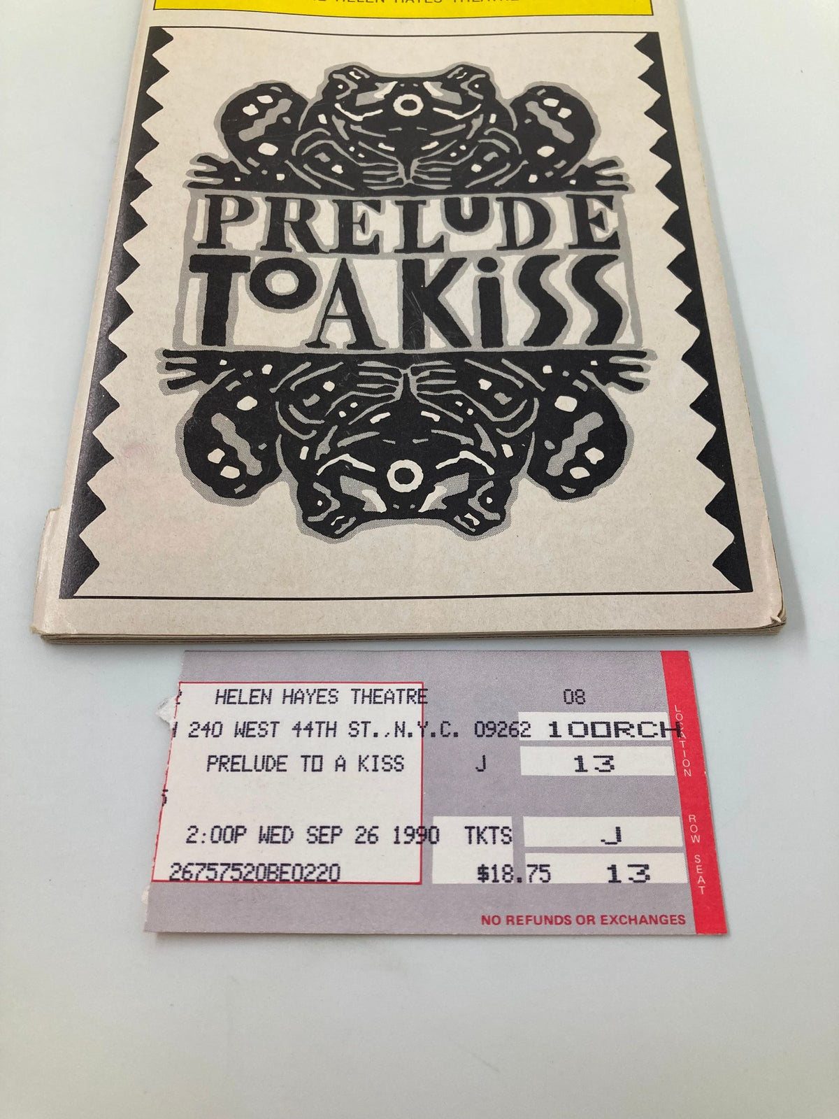 Close-up of the 1990 Playbill for "Prelude To A Kiss" with ticket details, showcasing vintage theater memorabilia from The Helen Hayes Theatre.