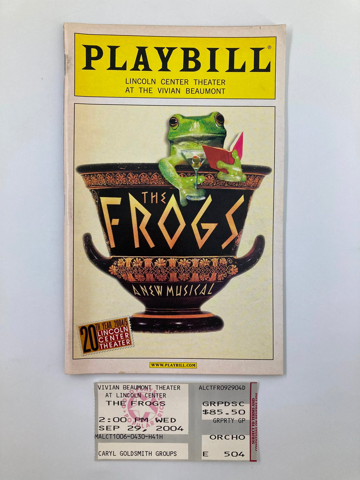 2004 Playbill for The Frogs at Lincoln Center Theater featuring a frog design and ticket stub, capturing the essence of Broadway memorabilia.
