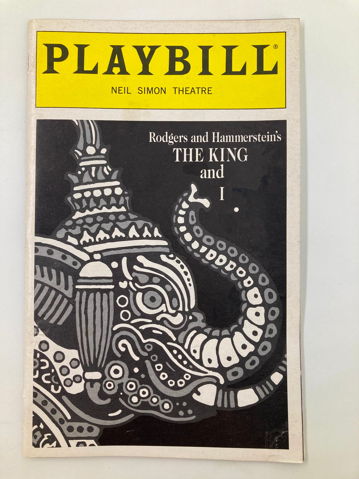 Cover of the 1997 Playbill for The King and I at Neil Simon Theatre featuring intricate elephant design.