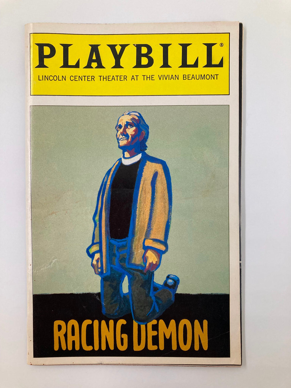 1995 Playbill for Lincoln Center Theater production of Racing Demon, featuring a colorful cover illustration of a character dressed in a coat, representing the vibrant theater scene.