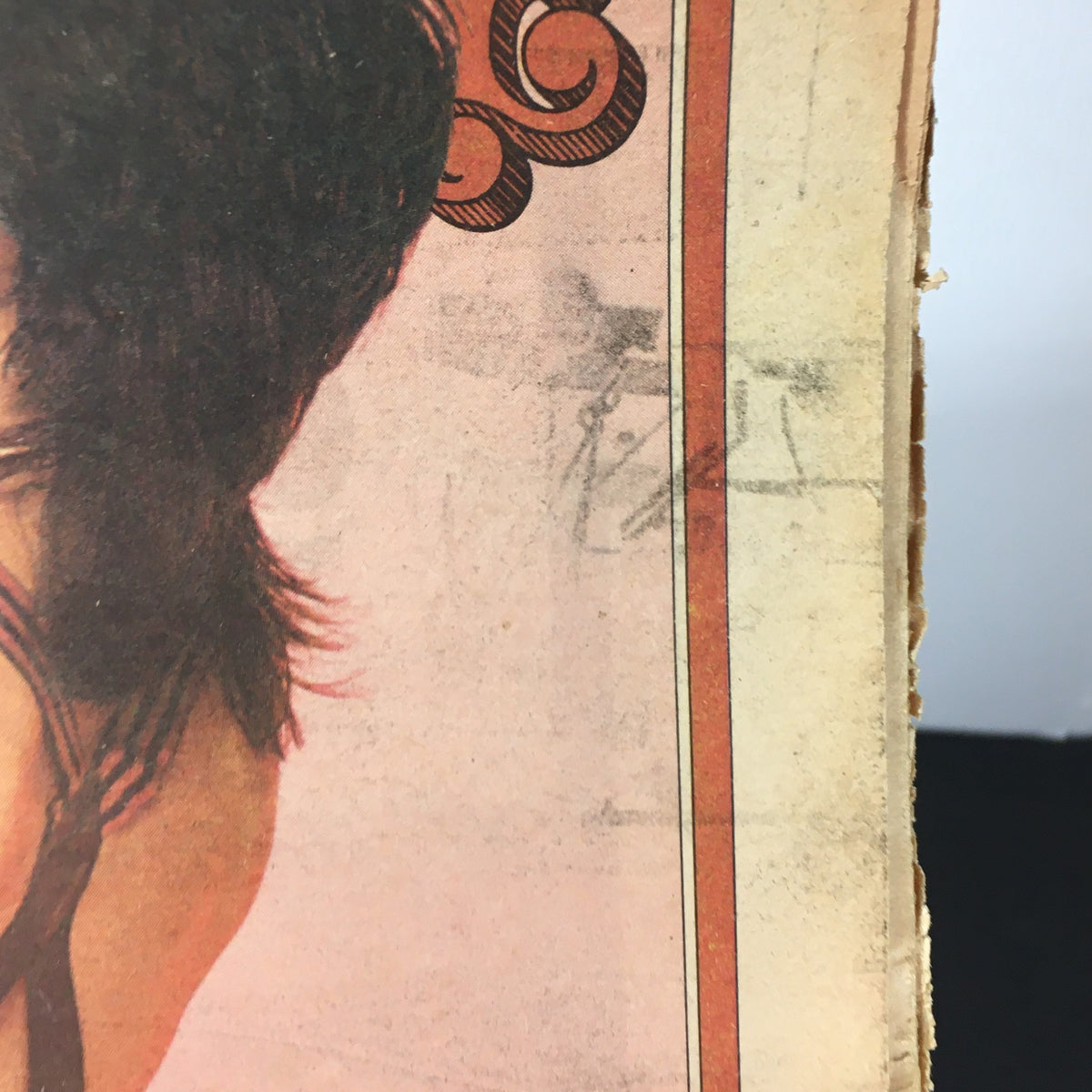 Close-up of the corner of a vintage Rolling Stone Magazine from November 3, 1977 featuring Mick Jagger and Keith Richards, showcasing age-related wear such as frayed edges and a faded design.
